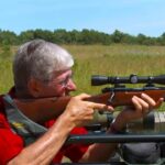 How do you sight in a rifle scope?